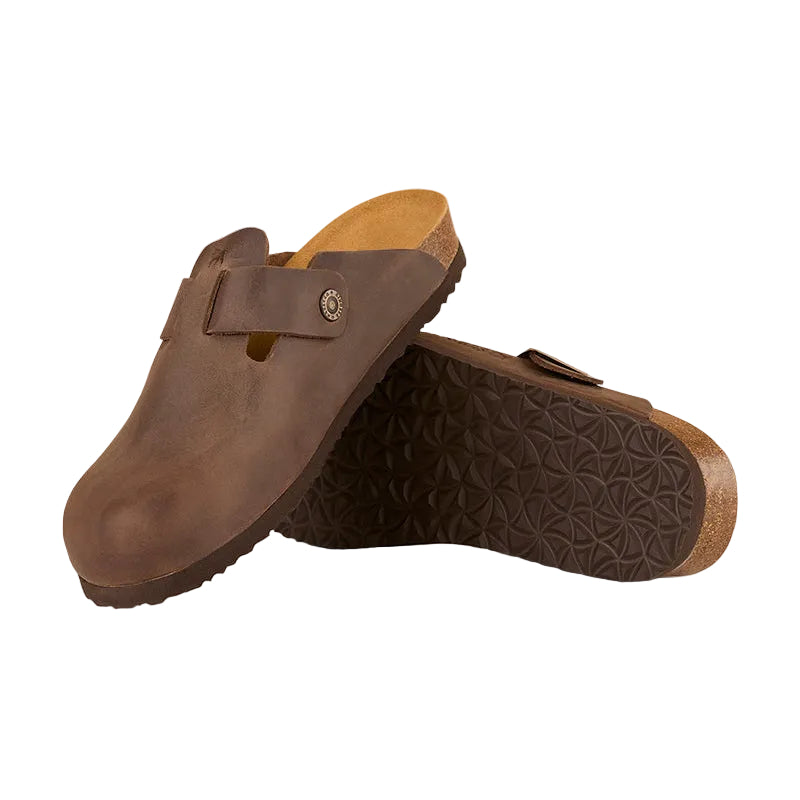 Pair of brown clogs on a light beige background