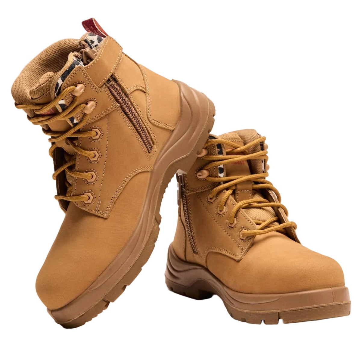 Pair of tan boots with zippers on a white background